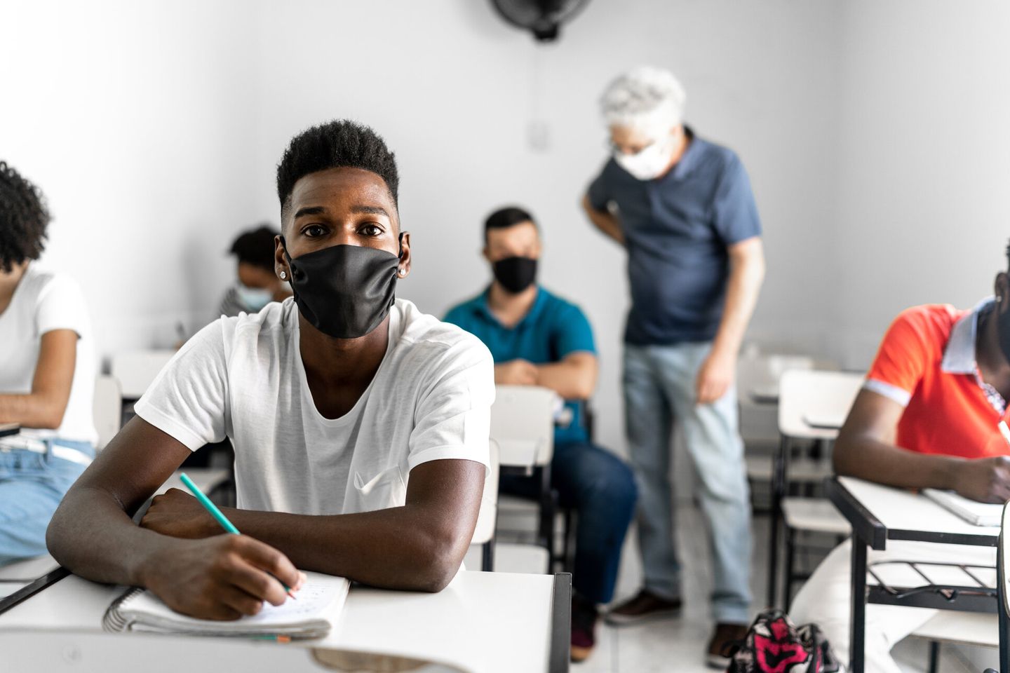 Portrait of an university / High school student wearing face mask in the classroom