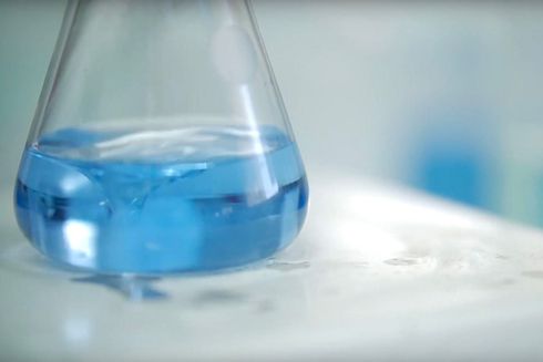 Recipiente de vidrio a medio llenar con químico azul. Ciencia y Desarrollo - Banco Interamericano de Desarrollo - BID 