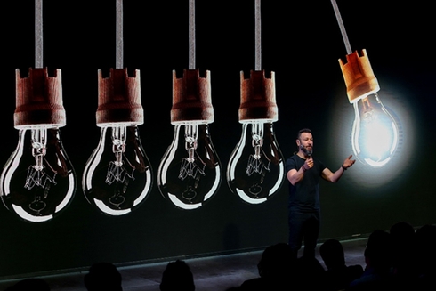 Light bulbs hang from the stage of a presentation