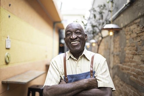 A man wearing an apron smiling. Funding - Inter-American Development Bank - IDB