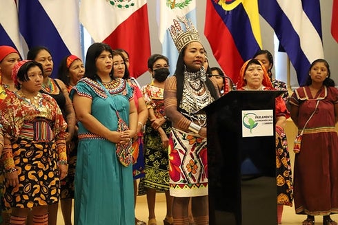 A group of indigenous women standing at a podium. Sustainable Development - Inter-American Development Bank - IDB