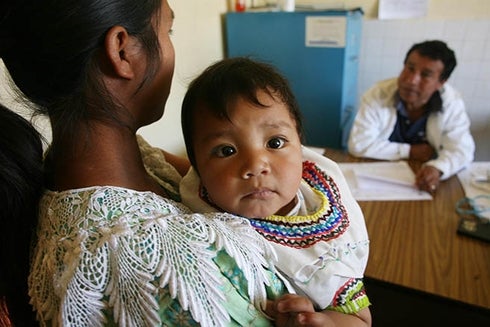 A woman holding a baby. Health - Inter-American Development Bank - IDB