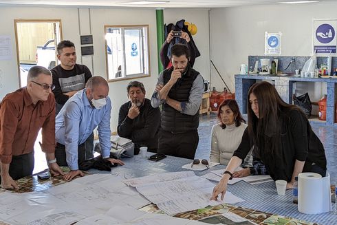 A group of people work on the plans of a construction project - Inter-American Development Bank - IDB