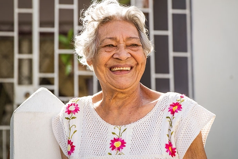 An older adult smiling at the camera