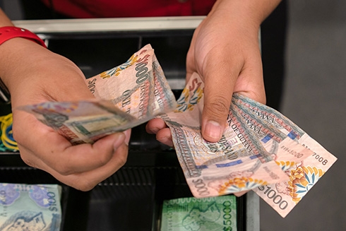 A person holding money in their hands