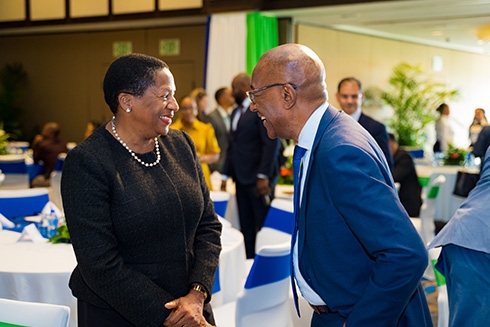 A man and a woman in a room smiling at each other