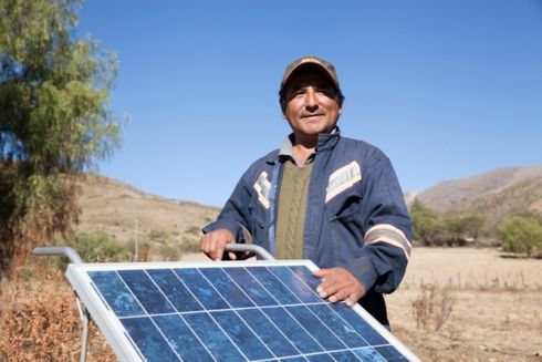 a person holding a solar panel