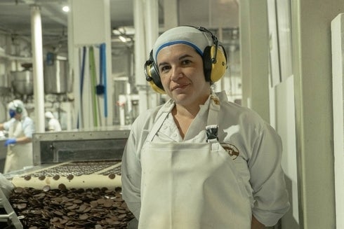 a person wearing headphones and a white apron