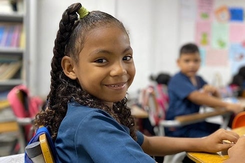 A child smiling at the camera. Sustainable Development - Inter-American Development Bank - IDB