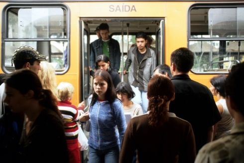 a group of people boarding a bus