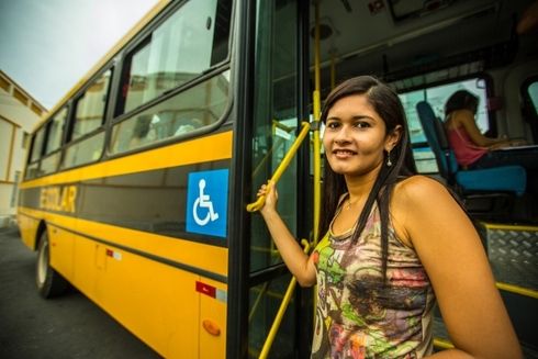a woman standing on a bus