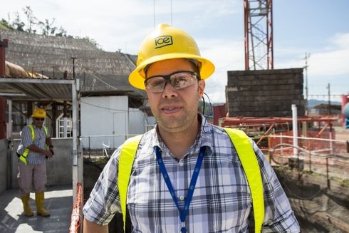 a person wearing a yellow hard hat and glasses