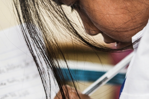 A girl is reading a notebook - Inter-American Development Bank - IDB