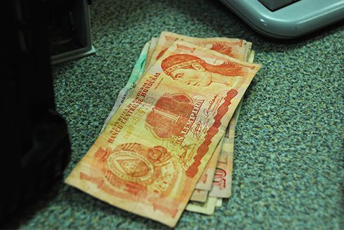 A stack of banknotes on a desk