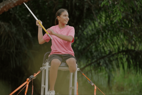 a child sitting on a chair holding a pole Social - Inter-American Development Bank - IDB