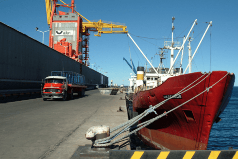 a red boat in a dock Trade - Inter-American Development Bank - IDB