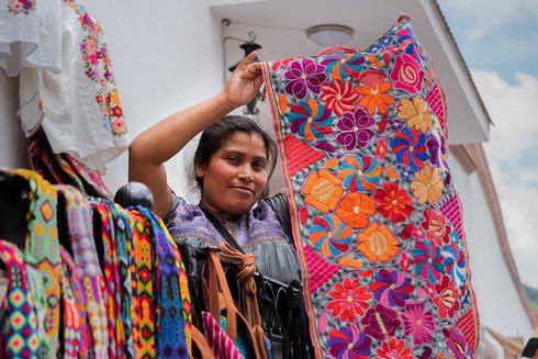 a person holding a colorful blanket Employment - Inter-American Development Bank - IDB