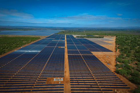 A large solar farm with persony solar panels  Investment - Inter-American Development Bank - IDB