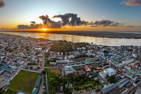 A city with a body of water and a sunset -  Sustainable Development - Inter-American Development Bank - IDB
