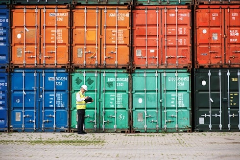 Man Taking Notes Next To Containers- Investor - Inter American Development Bank - IDB