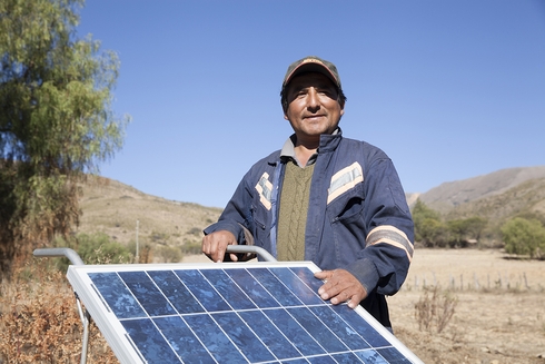Farmer holding a solar panel - Financial Development - Inter American Development Bank - IDB