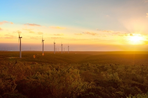 Landscape of wind power towers and sunset - Inter American Development Bank - IDB Environmental and Social Solutions