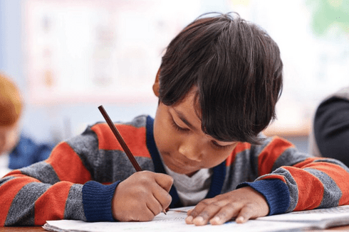 Child writing on a school - Education Initiatives- Inter American Development Bank - IDB