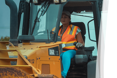 Brunette woman driving a tractor - Inter American Development Bank - Impact Framework
