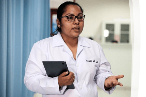 Female doctor talking in a hospital with her hand held - Inter American Development Bank - Impact Framework