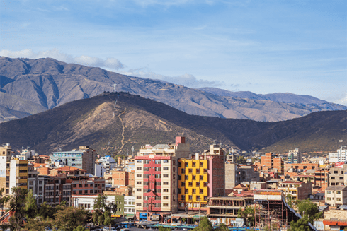 Panoramic view of city with buildings and big mountains in the background - Inter American Development Bank - Amazonia