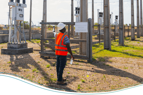 Afro-descendant worker looking up at the sky at a power plant- Inter American Development Bank - Regional Integration