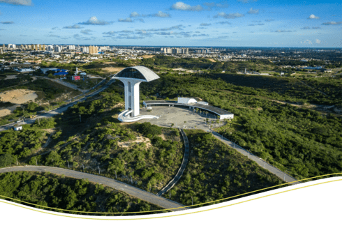 Panoramic day view of a city with trees and buildings - Inter American Development Bank - Regional Integration