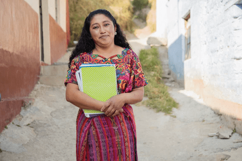 Teacher with books - Education - Inter American Development Bank - IDB