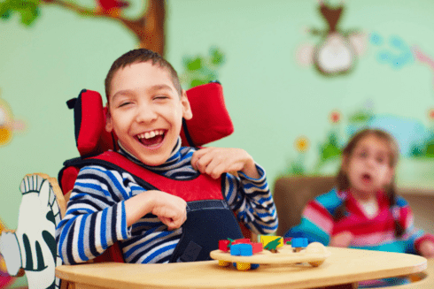 Kids smiling in a school - Inclusion of people with disabilities - Inter American Development Bank - IDB