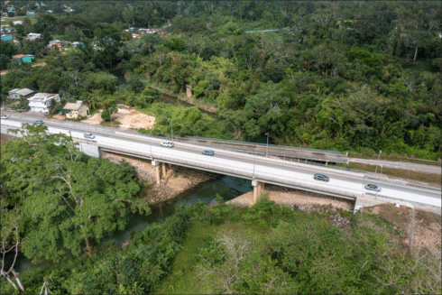 Road bridge crossing a river in a forested area IDB