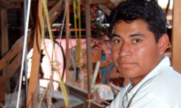 A man showing working on a weaving - Inter-American Development Bank - IDB