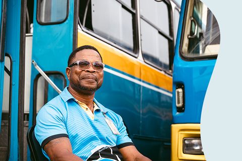 Black man sitting and calm with buses - Inter American Development Bank - IDB Strategy