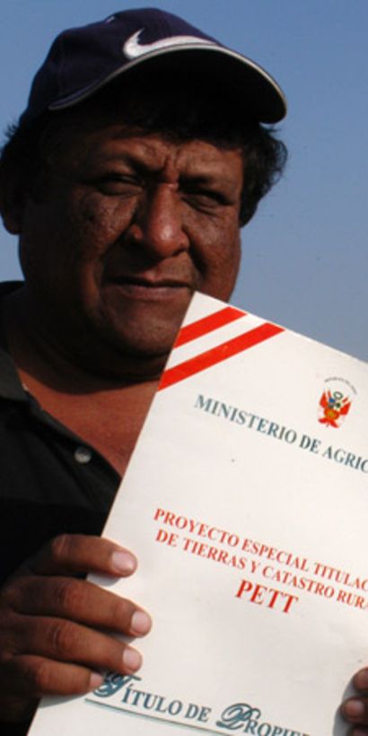 A man showing a title deed to his land - Inter-American Development Bank - IDB