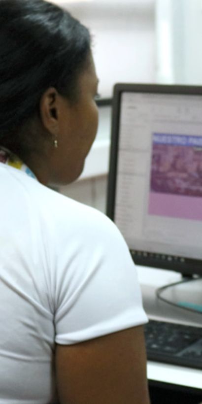 A woman sitting at a computer. Environment - Inter-American Development Bank - IDB